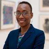 Valeda Dent with art exhibition in the background