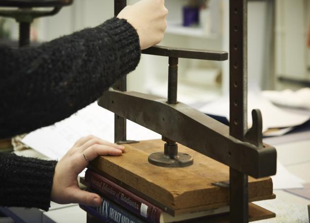 Student assistants often work in the Conservation Lab and learn to treat library collection material. Photo by Paige Knight