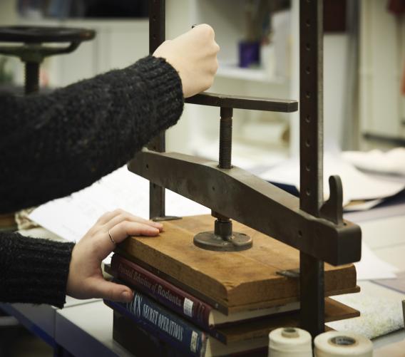Student assistants often work in the Conservation Lab and learn to treat library collection material. Photo by Paige Knight