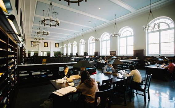 Students, periodical shelves, and windows in the Matheson Reading Room