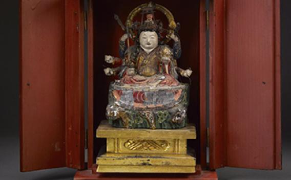 High definition photo of ancient Asian statue in a cabinet