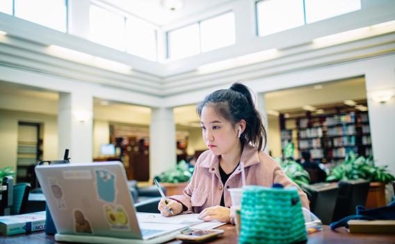 Student listening to class on laptop