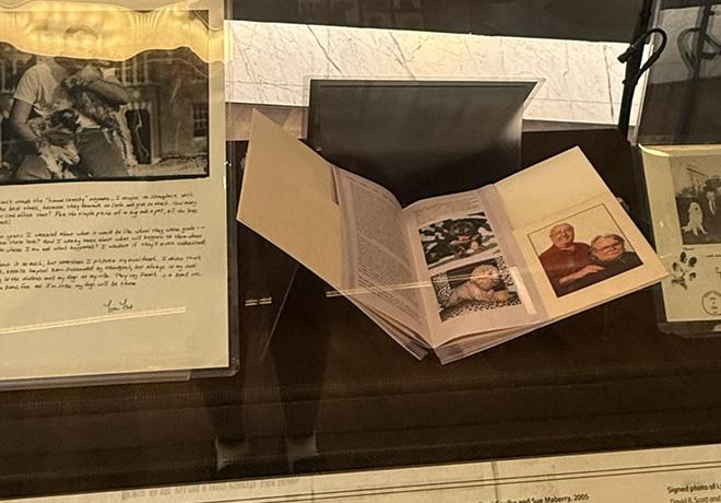 Exhibit display with archival photos of dogs and their owners